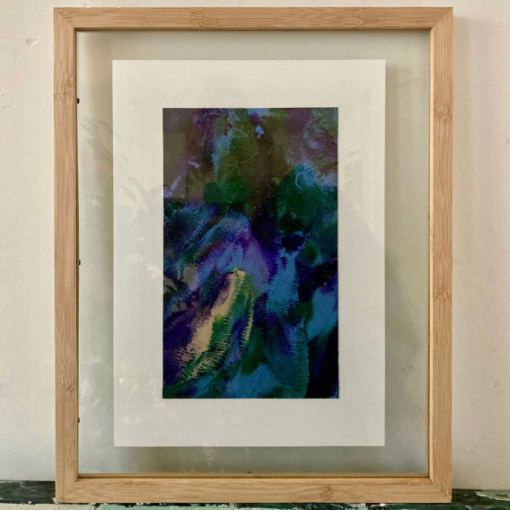 A framed abstract artwork in cool colors
